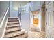 Light and bright entryway features beautiful stairs, tile floors, and access to the kitchen at 23070 York Ave, Parker, CO 80138