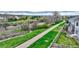 Exterior view of the walking path, lush greenbelt, and neighborhood homes on an overcast day at 23070 York Ave, Parker, CO 80138
