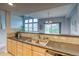 Open kitchen with stainless steel sink, breakfast bar, and views of the living spaces at 23070 York Ave, Parker, CO 80138