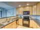 Efficient kitchen features wood cabinets, stainless appliances, and a breakfast bar at 23070 York Ave, Parker, CO 80138