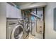 Well-equipped laundry room with modern washer, dryer, and mechanicals at 23070 York Ave, Parker, CO 80138