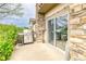 Outdoor patio area with a stone pillar, sliding glass door and stainless steel gas grill at 23070 York Ave, Parker, CO 80138