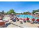 Exterior shot of a community pool on a sunny day with many lounge chairs surrounding it at 23070 York Ave, Parker, CO 80138