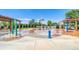 Community splash pad featuring various colorful water features and picnic tables for gatherings at 23070 York Ave, Parker, CO 80138