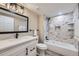Modern bathroom with stylish vanity, decorative mirror, and bathtub with tiled walls at 2944 Zuni St # B, Denver, CO 80211