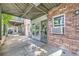 Exterior shot of the building with a brick facade, sheltered patio and large windows at 2944 Zuni St # B, Denver, CO 80211
