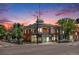 Street-level exterior showcasing the building's corner location and vintage architectural features against a vibrant sunset at 2944 Zuni St # B, Denver, CO 80211
