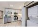 Bright kitchen with stainless steel appliances and white cabinets at 2944 Zuni St # B, Denver, CO 80211