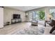 Cozy living room with a comfortable chair, large windows, and natural light at 2944 Zuni St # B, Denver, CO 80211
