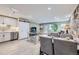 Bright living room with modern kitchen, tv, open floorplan and exposed stone wall at 2944 Zuni St # B, Denver, CO 80211