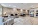 Open-concept living room featuring a stone wall, modern flooring and stainless steel appliances at 2944 Zuni St # B, Denver, CO 80211