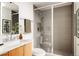 Modern bathroom with a glass-enclosed shower and updated vanity with natural wood tones at 3233 Tejon St # 103, Denver, CO 80211