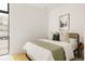 Inviting bedroom with a comfortable bed, stylish pillows, and a framed city print for a modern touch at 3233 Tejon St # 103, Denver, CO 80211