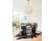 Bright, open dining room area with hardwood floors, black table and stylish decor at 3233 Tejon St # 103, Denver, CO 80211