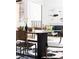 The dining area is staged with stylish decor on a round table over a cow hide rug at 3233 Tejon St # 103, Denver, CO 80211