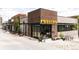 Charming building with wood and brick exterior, and an inviting patio area at 3233 Tejon St # 103, Denver, CO 80211