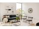Bright living room featuring modern artwork, comfortable seating, and stylish decor at 3233 Tejon St # 103, Denver, CO 80211
