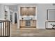 Wet bar features wood cabinets, a beverage fridge, and modern lighting at 2800 S University Blvd # 170, Denver, CO 80210