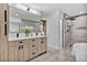 Bright bathroom with a double sink vanity, walk-in shower, and a soaking tub at 2800 S University Blvd # 170, Denver, CO 80210