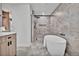 Bright bathroom with large tiles, walk-in shower, and a soaking tub at 2800 S University Blvd # 170, Denver, CO 80210