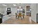 Open dining room with a modern light fixture, fireplace, and stainless steel appliances at 2800 S University Blvd # 170, Denver, CO 80210
