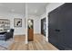 Bright entryway with light wood floors, black accent doors, and modern decor at 2800 S University Blvd # 170, Denver, CO 80210
