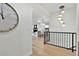 Open hallway with hardwood floors, white walls, and hanging lights at 2800 S University Blvd # 170, Denver, CO 80210