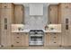 Kitchen showcases wood cabinets, a stainless steel range, and white backsplash tiles at 2800 S University Blvd # 170, Denver, CO 80210