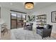 Cozy living room features a large window, stylish rug, and comfortable seating at 2800 S University Blvd # 170, Denver, CO 80210