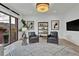 Comfortable living room includes modern shelving, accent chairs, and bright lighting at 2800 S University Blvd # 170, Denver, CO 80210