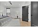 Spacious main bedroom with a comfy bed, accent chairs, and neutral decor at 2800 S University Blvd # 170, Denver, CO 80210