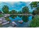 Scenic view of the pond with the trees reflecting in the water, surrounded by boulders and green landscaping at 2800 S University Blvd # 170, Denver, CO 80210