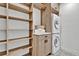 Spacious walk-in closet with built-in shelves and an adjacent laundry area at 2800 S University Blvd # 170, Denver, CO 80210