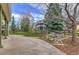Backyard with lush lawn, mature trees, and patio with partial home view at 10824 Quail Ridge Dr, Parker, CO 80138