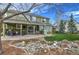 Expansive backyard with patio, mature trees, and two-story home at 10824 Quail Ridge Dr, Parker, CO 80138