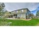 Green two-story home with a spacious backyard and covered patio area at 10824 Quail Ridge Dr, Parker, CO 80138