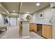 Stylish bar area with counter seating, cabinetry, and convenient beverage storage at 10824 Quail Ridge Dr, Parker, CO 80138
