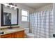 Traditional bathroom featuring a decorative vanity, sink, and a shower with a curtain at 10824 Quail Ridge Dr, Parker, CO 80138