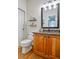 Charming half bathroom featuring a wooden vanity, updated fixtures, and decorative shelving at 10824 Quail Ridge Dr, Parker, CO 80138