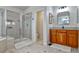 Beautiful bathroom boasting double vanity, and glass enclosed shower stall with tiled backsplash at 10824 Quail Ridge Dr, Parker, CO 80138