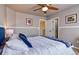 Cozy bedroom with a blue headboard and crisp white bedding, bathed in natural light at 10824 Quail Ridge Dr, Parker, CO 80138