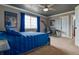 Comfortable bedroom with a large window, ceiling fan, and adjoining workspace at 10824 Quail Ridge Dr, Parker, CO 80138