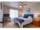 Cozy bedroom with a blue headboard and crisp white bedding, bathed in natural light at 10824 Quail Ridge Dr, Parker, CO 80138