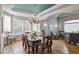 Elegant dining room with a statement chandelier, hardwood floors, and large windows offering natural light at 10824 Quail Ridge Dr, Parker, CO 80138