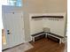 Well organized entryway with storage benches, coat hooks, and hardwood floors at 10824 Quail Ridge Dr, Parker, CO 80138