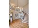 Grand foyer showcasing a curved staircase, hardwood floors, and an open, airy design at 10824 Quail Ridge Dr, Parker, CO 80138