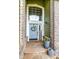 Charming entryway with a decorative wreath, 'Welcome' sign, and lovely potted flowers at 10824 Quail Ridge Dr, Parker, CO 80138