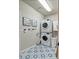 Laundry room boasts side-by-side appliances, patterned tile floors, and framed artwork at 10824 Quail Ridge Dr, Parker, CO 80138