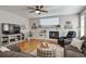 Cozy living room with a fireplace, entertainment center, and comfortable seating area at 10824 Quail Ridge Dr, Parker, CO 80138