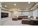 Spacious living room with cozy seating, recessed lighting, and entertainment setup at 10824 Quail Ridge Dr, Parker, CO 80138